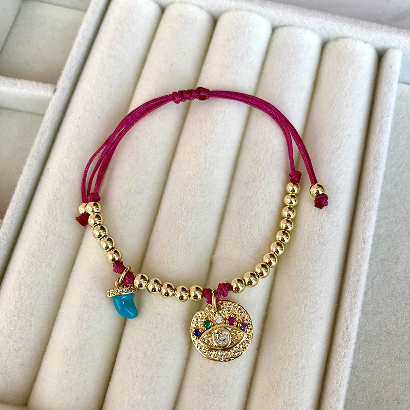 PULSERA OJO FUCSIA